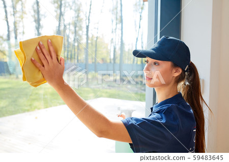 Caucasian woman washes panoramic window wearing uniform Caucasian woman washes panoramic window wearing uniform 59483645