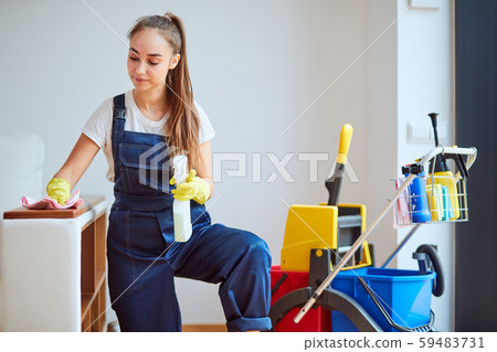 Young and beautiful janitor cleaning room 59483731