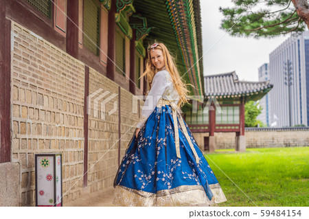 Young caucasian female tourist in hanbok national korean dress at Gyeongbokgung Palace. Travel to Young caucasian female tourist in hanbok national korean dress at Gyeongbokgung Palace. Travel to 59484154