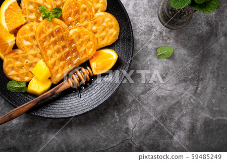 Healthy breakfast with fresh hot waffles hearts, pancakes flowers Healthy breakfast with fresh hot waffles hearts, pancakes flowers 59485249