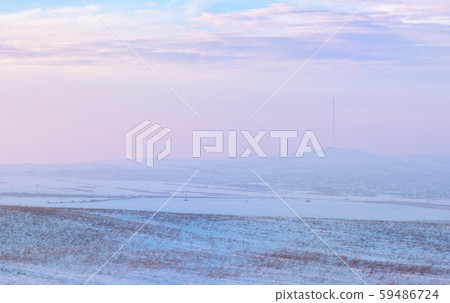 Sunset over hills covered with snow Sunset over hills covered with snow 59486724