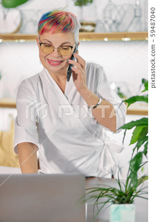 Female florist search specific information about flora using laptop Female florist search specific information about flora using laptop 59487040