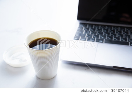 Working on a laptop while drinking coffee. Business or work. At-home work, telework and side jobs. Working on a laptop while drinking coffee. Business or work. At-home work, telework and side jobs. 59487044