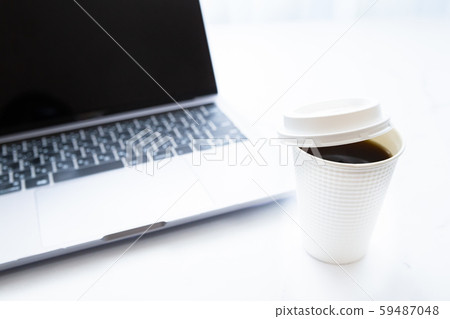 Working on a laptop while drinking coffee. Business or work. At-home work, telework and side jobs. Working on a laptop while drinking coffee. Business or work. At-home work, telework and side jobs. 59487048