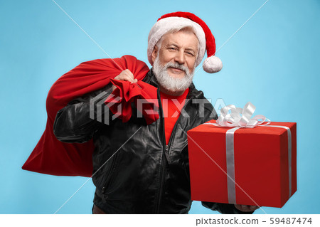 Front view of bearded man in Santa hat with gift boxes Front view of bearded man in Santa hat with gift boxes 59487474