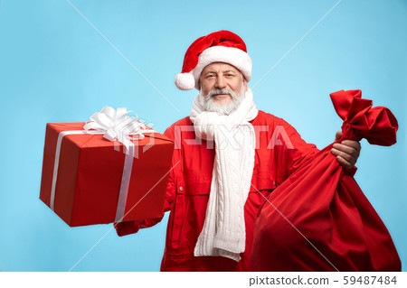 Happy bearded Santa Claus with red gift box and big sack 59487484