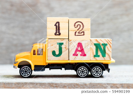 Truck hold letter block in word 12jan on wood background Truck hold letter block in word 12jan on wood background 59490199