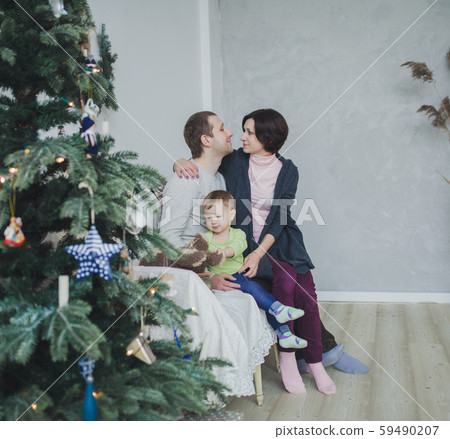 happy family near decorated Christmas tree 59490207