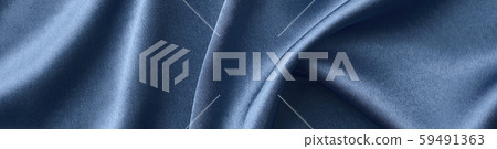 Silver silk background with a folds. Abstract texture of rippled silk surface Silver silk background with a folds. Abstract texture of rippled silk surface 59491363