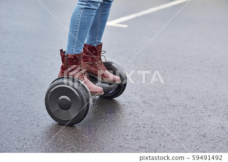 Close up of woman using hoverboard on asphalt 59491492