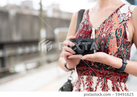 mature Asian woman using digital camera mature Asian woman using digital camera 59491625