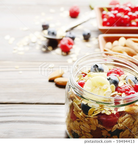 Fruit muesli in glass jar on kitchen wooden table 59494413