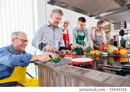 Nutritionist and trainees in a training kitchen Nutritionist and trainees in a training kitchen 59494508
