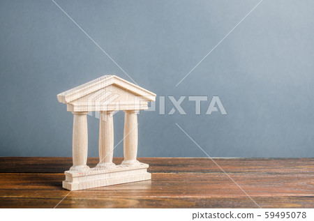 Building figurine with pillars in antique style. Concept of city administration, bank, university, court or library. Architectural monument in the old part of the town. Banking, education, government. Building figurine with pillars in antique style. Concept of city administration, bank, university, court or library. Architectural monument in the old part of the town. Banking, education, government. 59495078