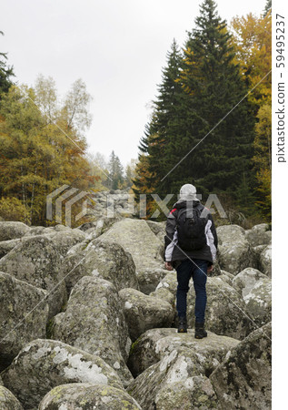 Young man on a volcanic stones Young man on a volcanic stones 59495237