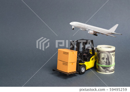 A forklift truck carries cardboard boA forklift truck carries cardboard boxes near a dollar roll and airplane. Transport company. Performance efficient. Trade and production of products and xes near a 59495259