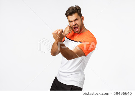 Sport and active lifestyle concept. Serious sexy handsome sportsman with big muscles, showing strong 59496640