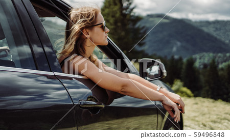Happy woman travels by car in the mountains. Summer vacation concept 59496848