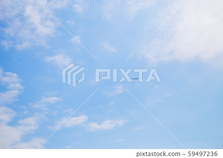The plane flies away in a beautiful blue sky 59497236