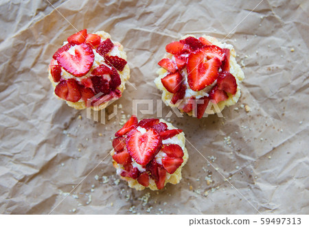 Very tasty muffins with fresh strawberries lie on 59497313