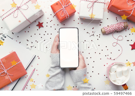 Modern cellphone with white blank screen in woman hands 59497466