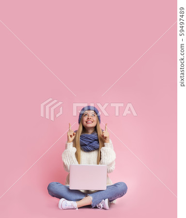 Girl with laptop showing up at empty space Girl with laptop showing up at empty space 59497489