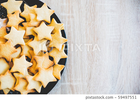 Butter Cookies in black ceramic dish on wood table Butter Cookies in black ceramic dish on wood table 59497551