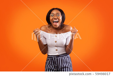 Excited Afro Lady Shouting Shaking Fists Celebrating Success, Studio Shot 59498017