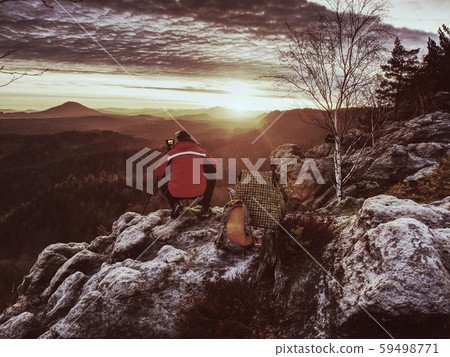 Photographer in red jacket and knitted cap stay Photographer in red jacket and knitted cap stay 59498771