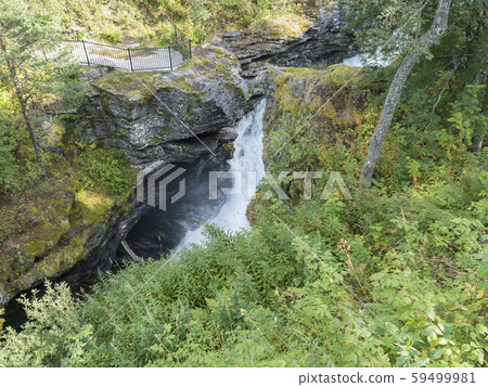 Waterfall Slettafossen at Verma with viewpoint platform deep narrow Rauma river canyon at Romsdalen 59499981