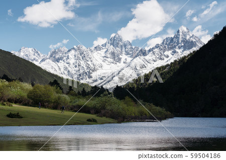 Snow mountains with green hill, forest and lake in Sichuan, China 59504186