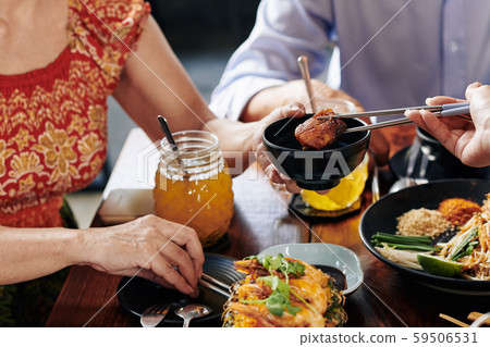 People eating Asian food at dinner 59506531