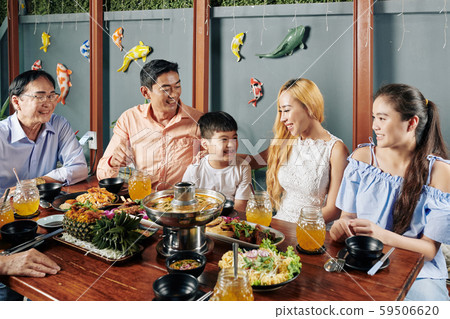 Big Asian family enjoying dinner together 59506620