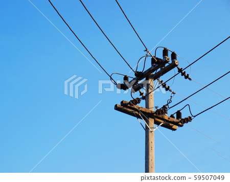 High voltage transmission line on the pole And changing the orthogonal way of laying high voltage electricity lines into communities or cities on a blue background With copy space. High voltage transmission line on the pole And changing the orthogonal way of laying high voltage electricity lines into communities or cities on a blue background With copy space. 59507049