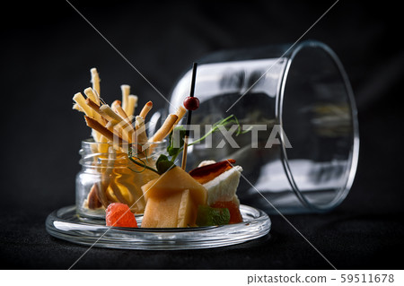 Assorted cheeses with berries and marmalade, mini serve in a glass flask. Fusion food concept, low Assorted cheeses with berries and marmalade, mini serve in a glass flask. Fusion food concept, low 59511678