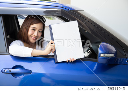 Happy Asian woman holding car insurance document Happy Asian woman holding car insurance document 59511945