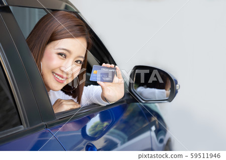 Happy young Asian woman holding payment card Happy young Asian woman holding payment card 59511946