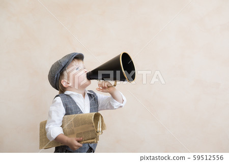 Child shouting through vintage megaphone Child shouting through vintage megaphone 59512556