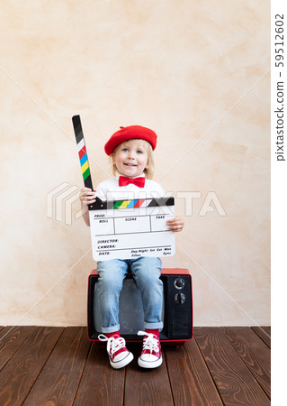 Funny kid holding clapper board Funny kid holding clapper board 59512602