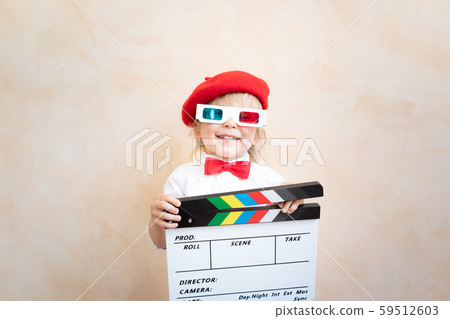 Funny kid holding clapper board Funny kid holding clapper board 59512603