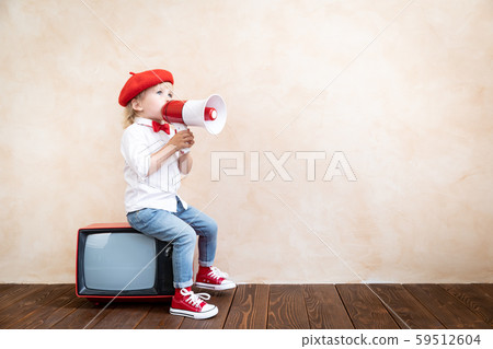 Child shouting through vintage megaphone Child shouting through vintage megaphone 59512604