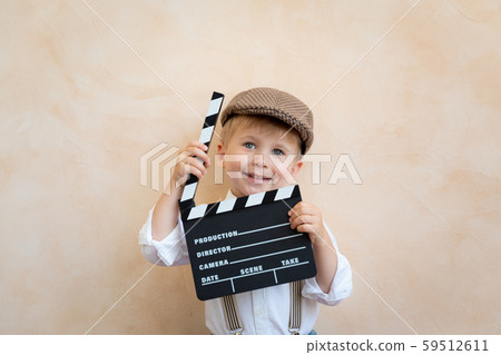 Funny kid holding clapper board 59512611