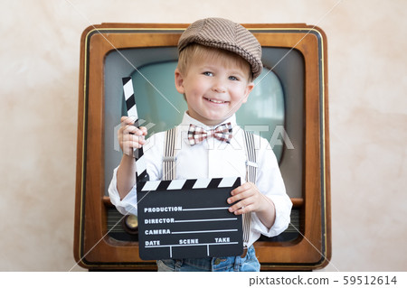 Funny kid holding clapper board 59512614