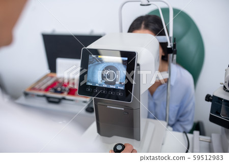 Close up of ophthalmologist using modern equipment while examining patient 59512983
