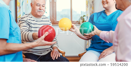 Group of seniors doing sport and gymnastics with balls 59514200