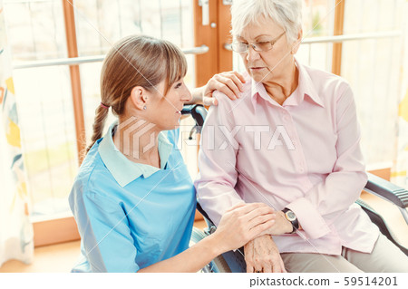 Caregiver and senior woman in nursing home 59514201
