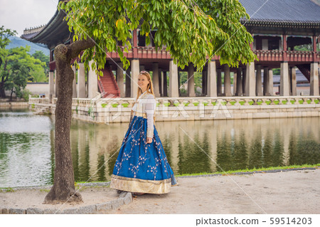 Young caucasian female tourist in hanbok national korean dress at Korean palace. Travel to Korea 59514203