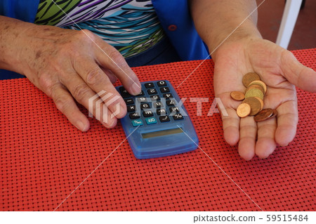 Cropped image of the retired woman's hands checking the finance Cropped image of the retired woman's hands checking the finance 59515484