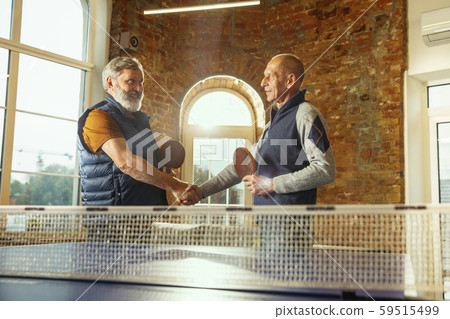Senior men playing table tennis in workplace, having fun 59515499