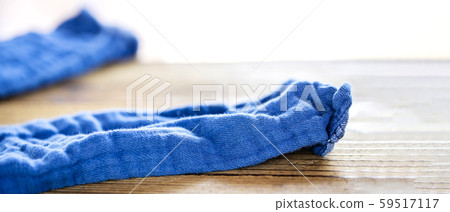 Blue pants stripped off on a wooden table Blue pants stripped off on a wooden table 59517117